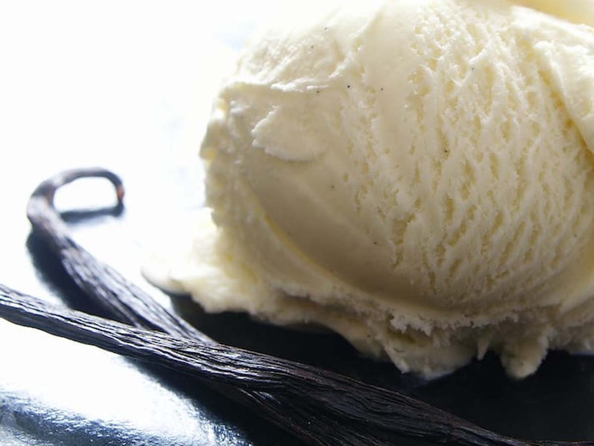 Creamy, scoopable homemade vanilla ice cream showing a smooth and rich texture.