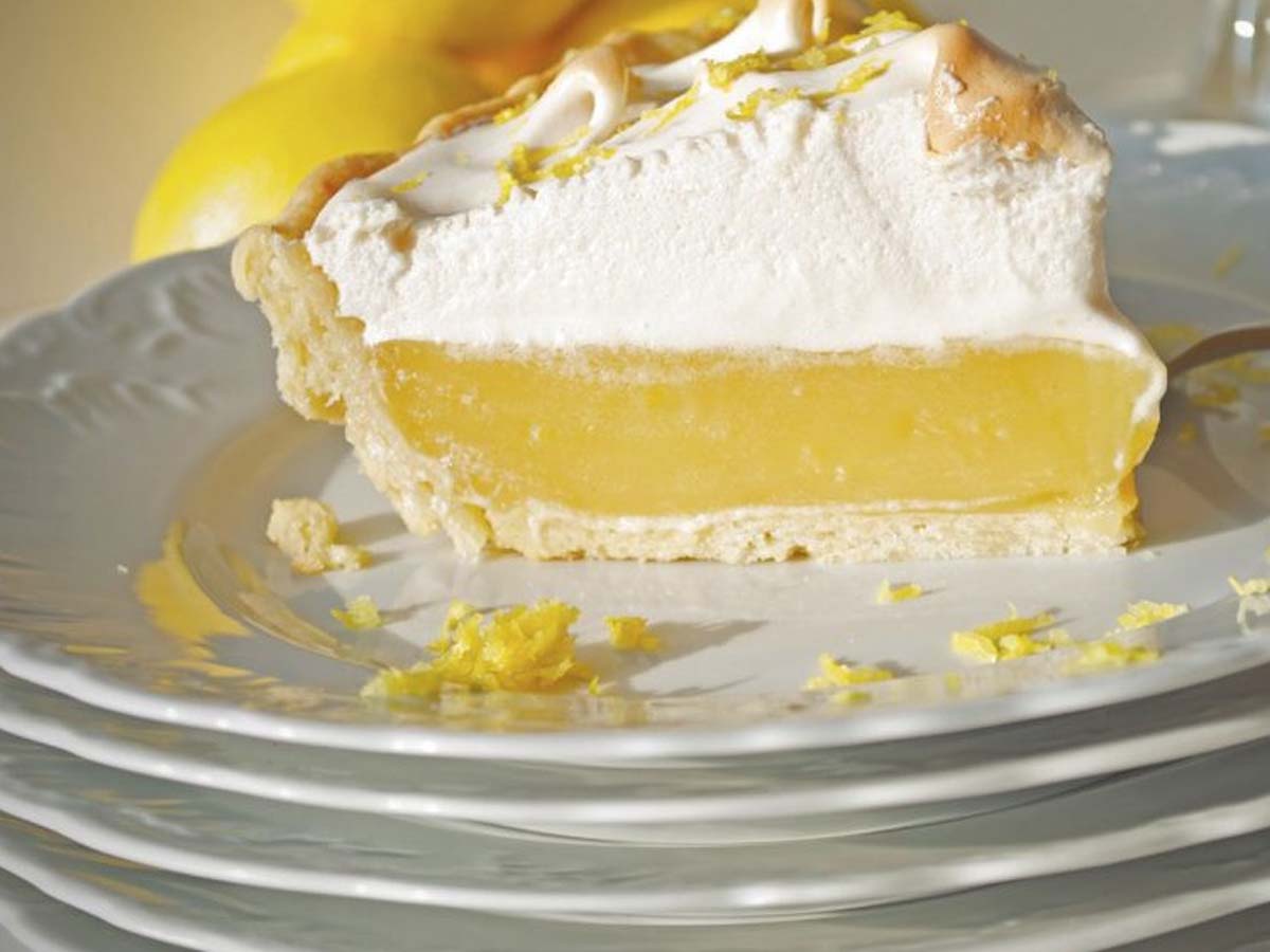 A stunning lemon meringue pie with high peaks of toasted golden meringue topping.