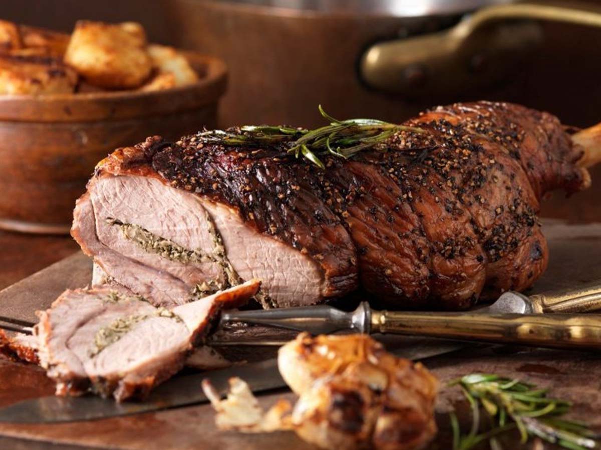 A succulent holiday roast lamb leg seasoned with herbs and cooked until tender.