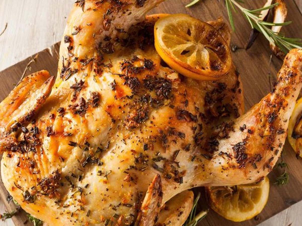 A perfectly golden traditional roast chicken served on a holiday platter.