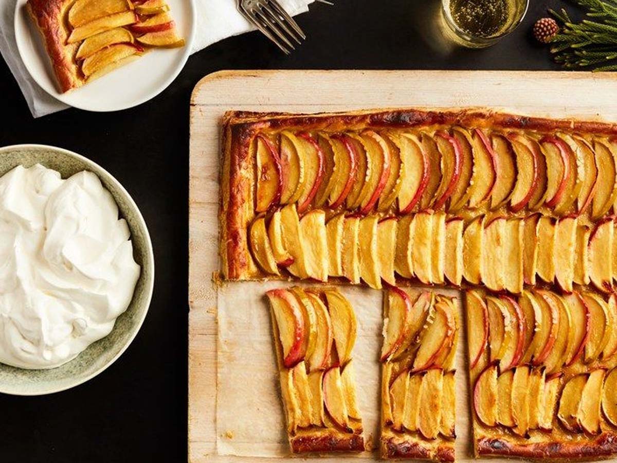 A sweet apple caramel tart with thinly sliced apples and a glossy caramel glaze.
