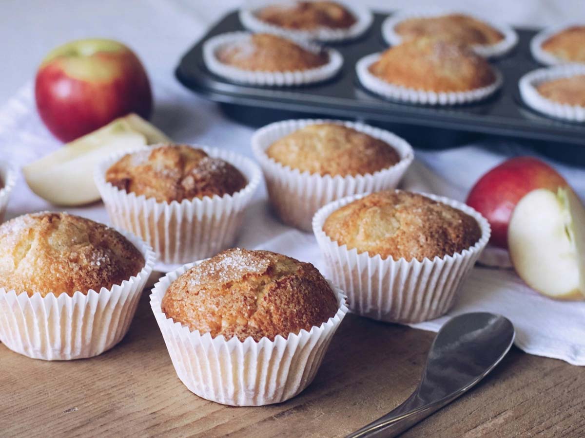 Freshly baked apple muffins flavoured with ginger and cinnamon, dusted with sugar.