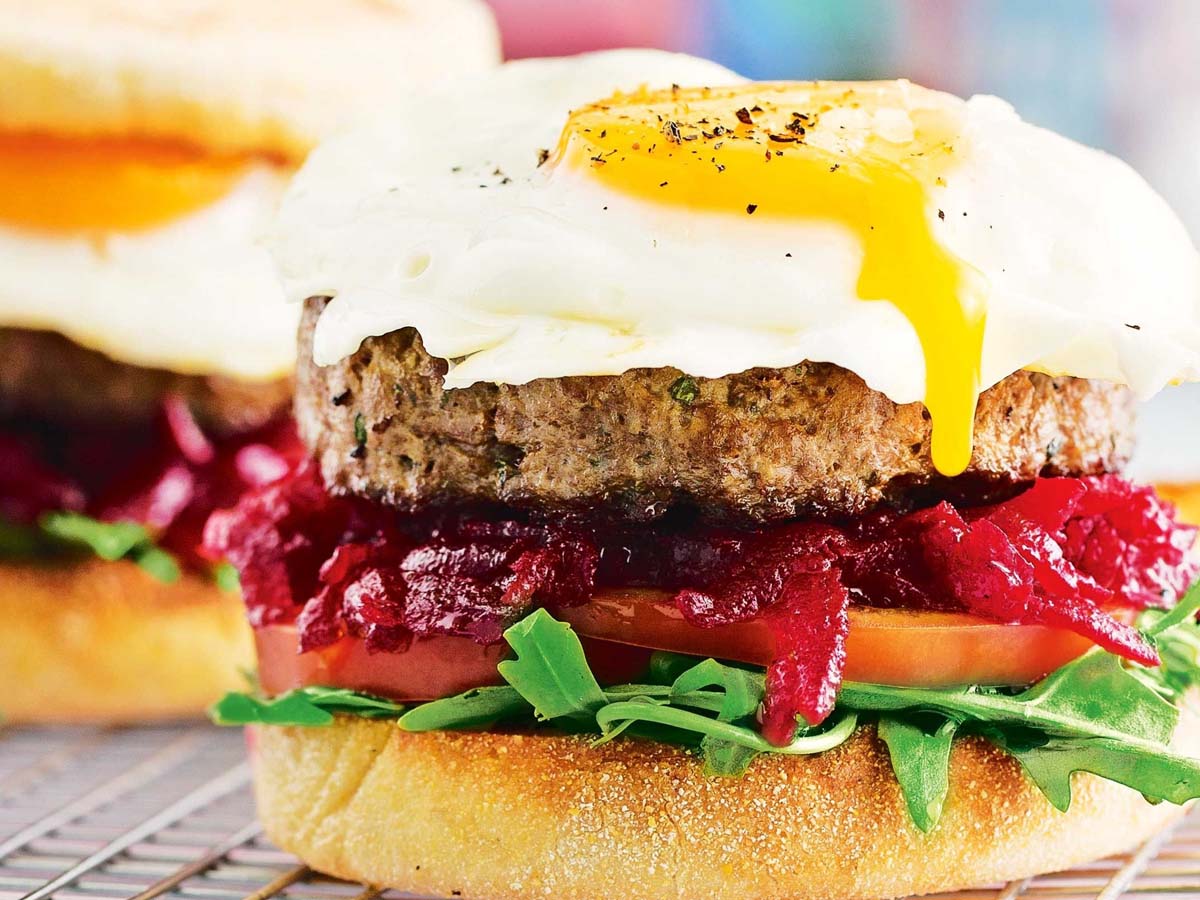 A massive classic Aussie beef burger stacked high with egg, beetroot, beef patty, and cheese.