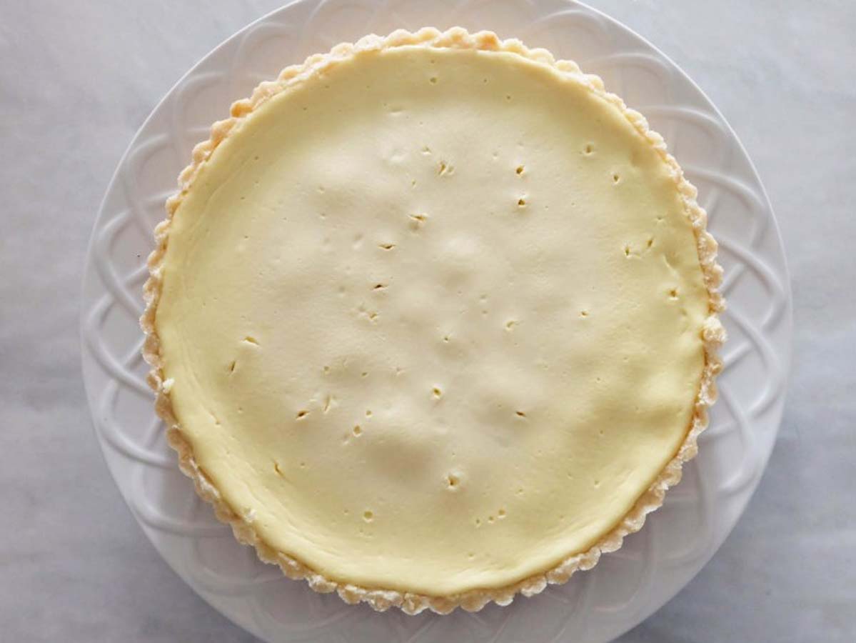 A traditional baked creamy Greek yogurt tart dessert showing a clean smooth surface.