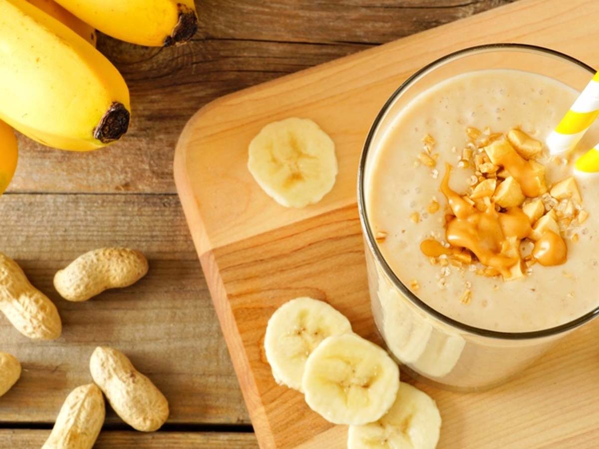 A thick, healthy blended banana and peanut butter smoothie protein shake cup.