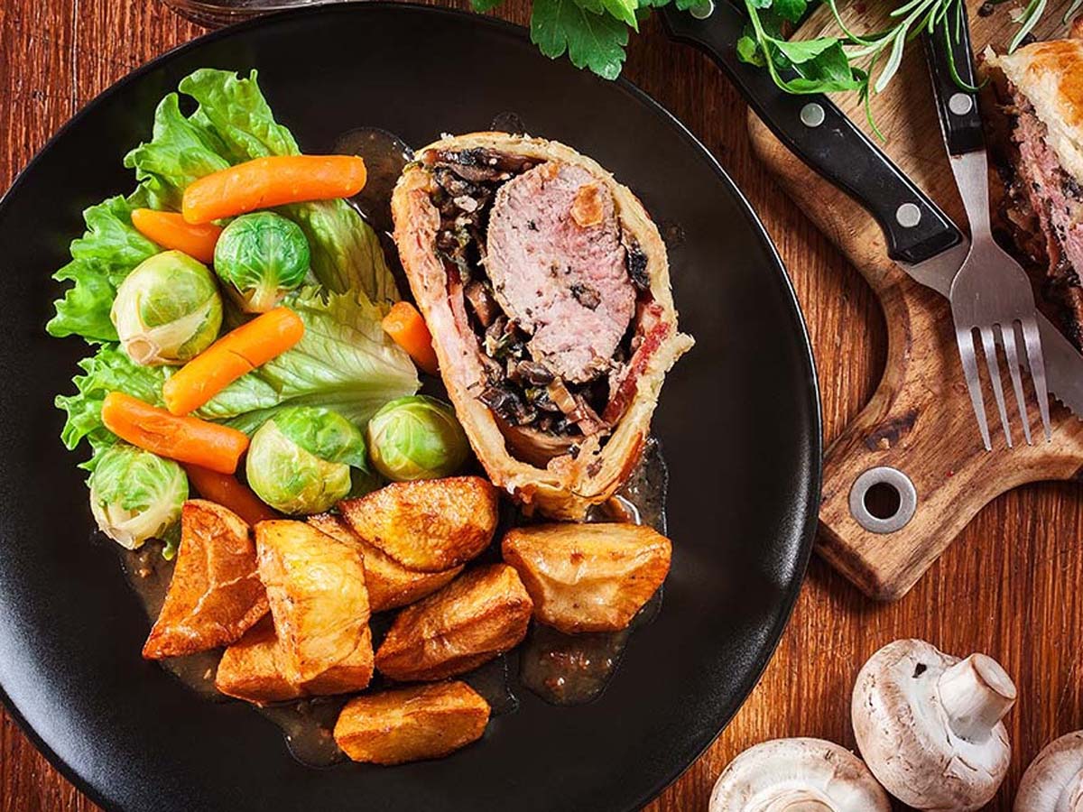 An exquisite classic beef wellington steak wrapped in mushroom duxelles and golden puff pastry.