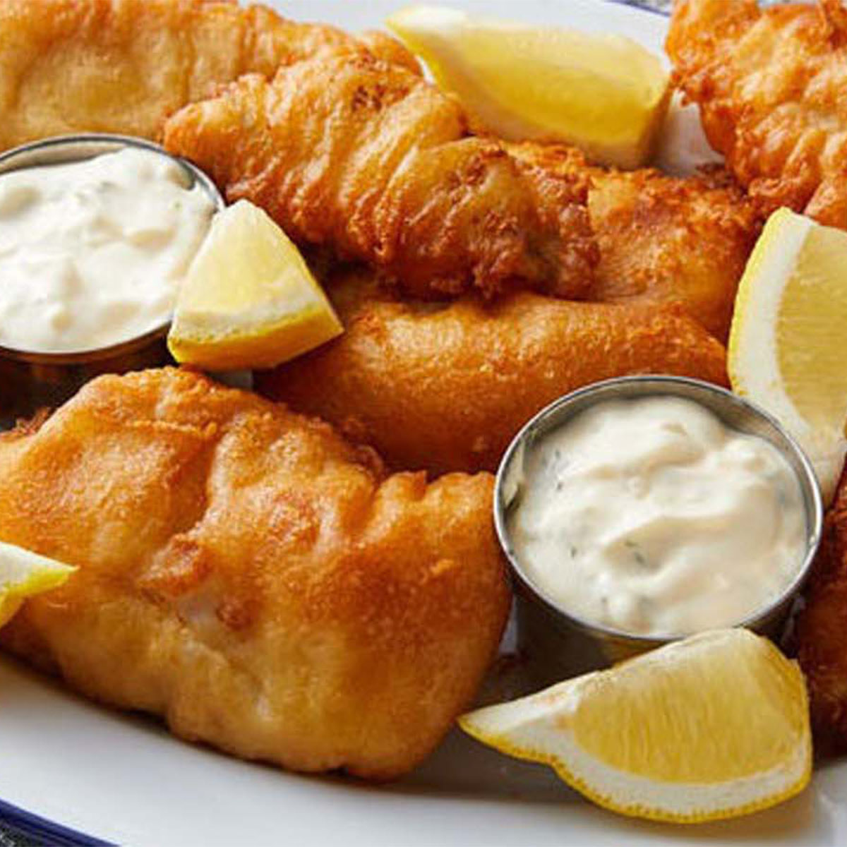 Crispy golden beer-battered fish fillets served with hot chips.