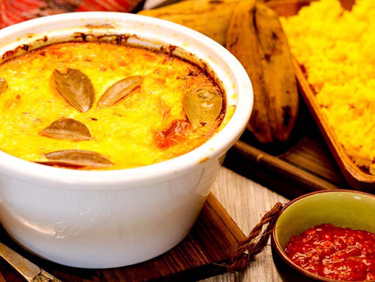 Traditional South African baked savoury minced beef Bobotie served with bright yellow turmeric rice.