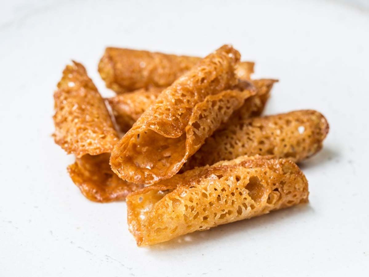Crisp and golden lace-like brandy snaps rolled into delicate tubes.
