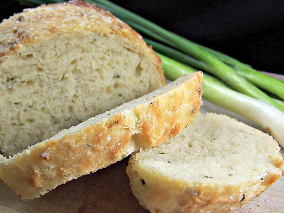 A savoury loaf of quick bread filled with melted cheese, fresh chives, and onions.