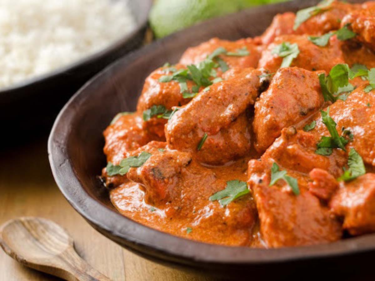 A popular bowl of creamy, orange spiced Indian chicken tikka masala curry chicken.