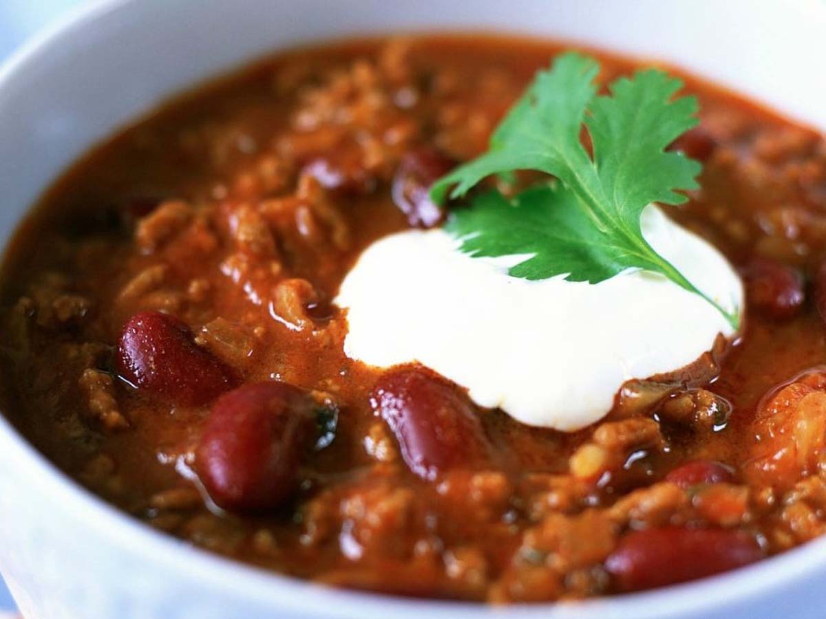 A deep bowl of hearty, spicy tex-mex chili con carne minced beef stew with beans.