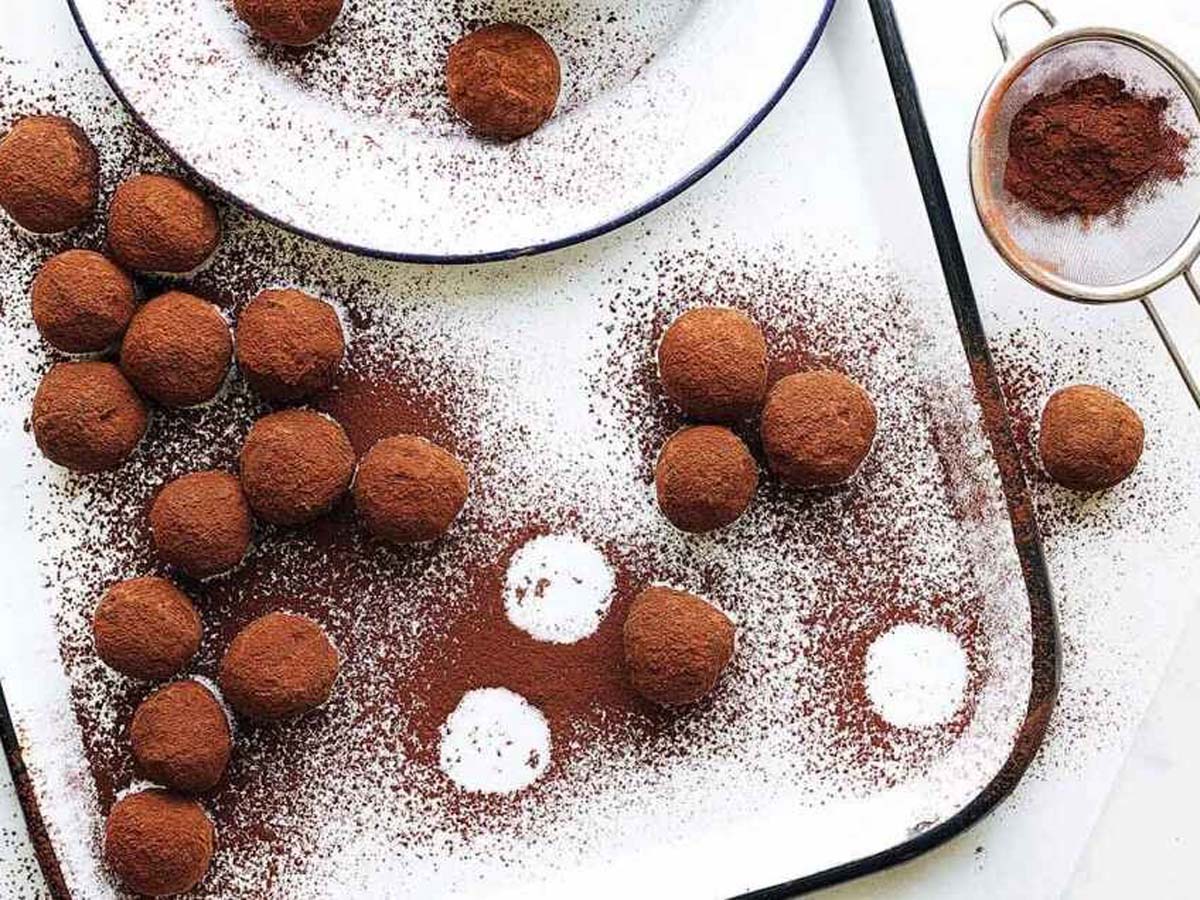 A luxury box of rich, dark chocolate truffles dusted beautifully in cocoa powder.