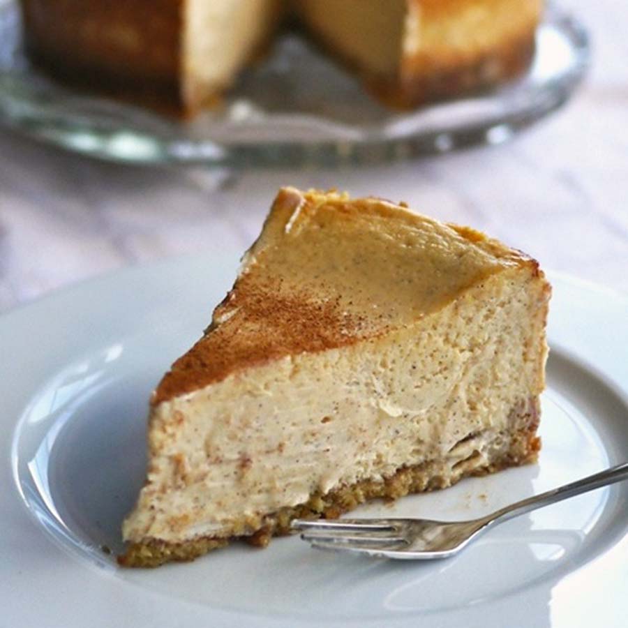 A delicious slice of baked cinnamon cheesecake with a spiced graham cracker crust base.