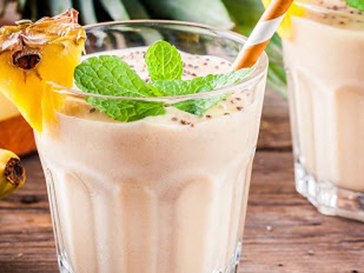 A refreshing, thick blended white coconut smoothie garnish with shredded coconut flakes.