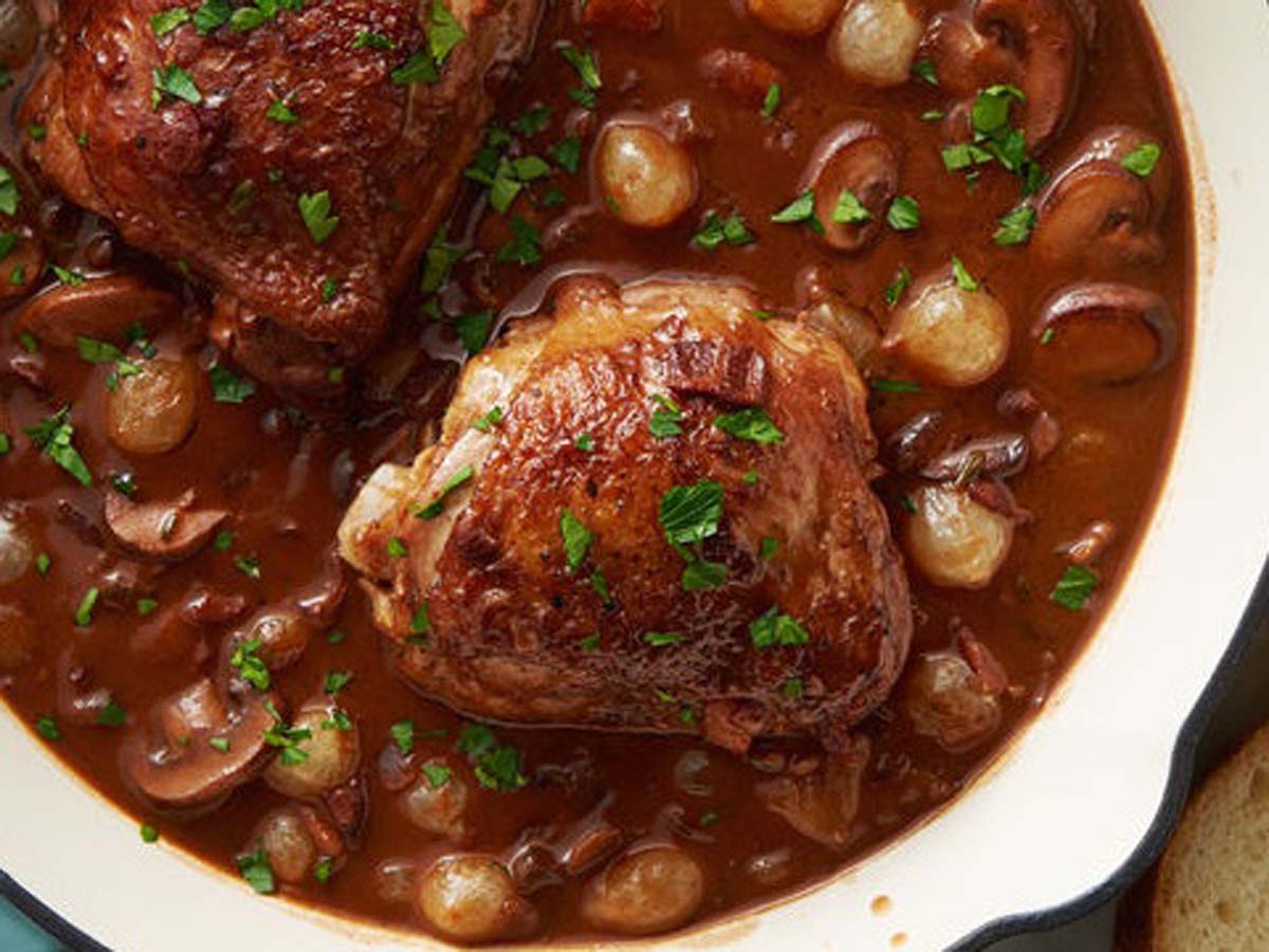 A traditional French coq au vin chicken stew braised in rich red wine sauce.