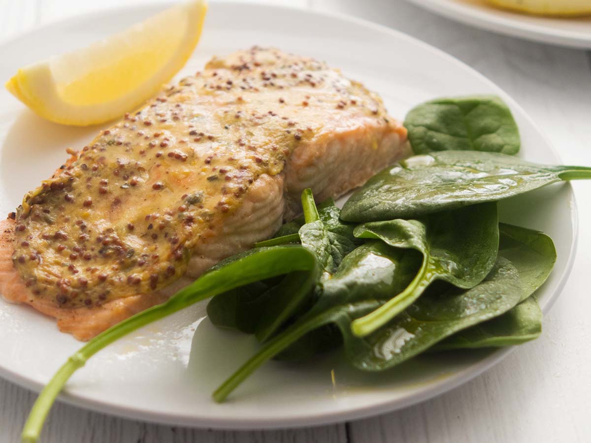 A rich and savoury creamy wholegrain mustard steak sauce showing textured mustard seeds.