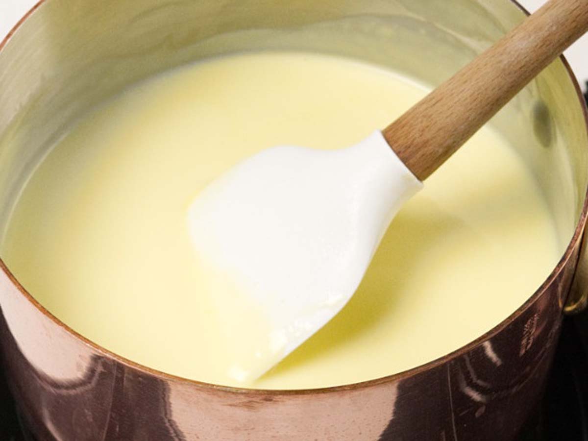 A smooth, creamy yellow pourable creme anglaise vanilla custard sauce.