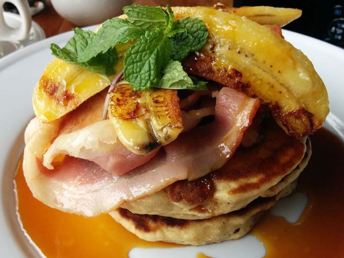 Fluffy breakfast crumpets topped with crispy bacon rashers and sweet caramelised banana slices.