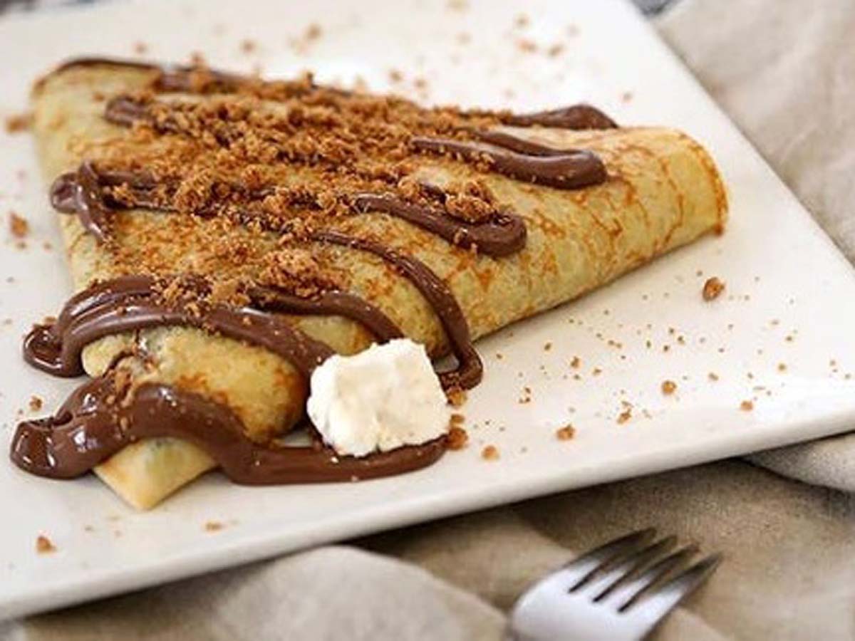 Thin sweet custard pancakes rolled up gently on a serving dish.