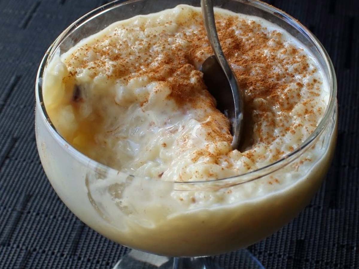 A comforting bowl of old-fashioned baked English rice pudding dusted with nutmeg.