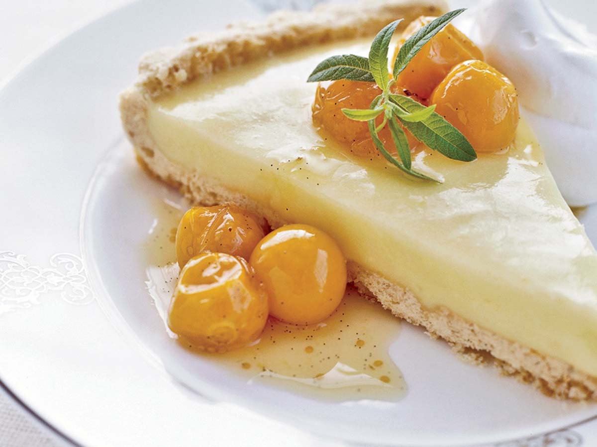 A sweet and tart baked gooseberry tart with a golden brown pastry lattice grid top.