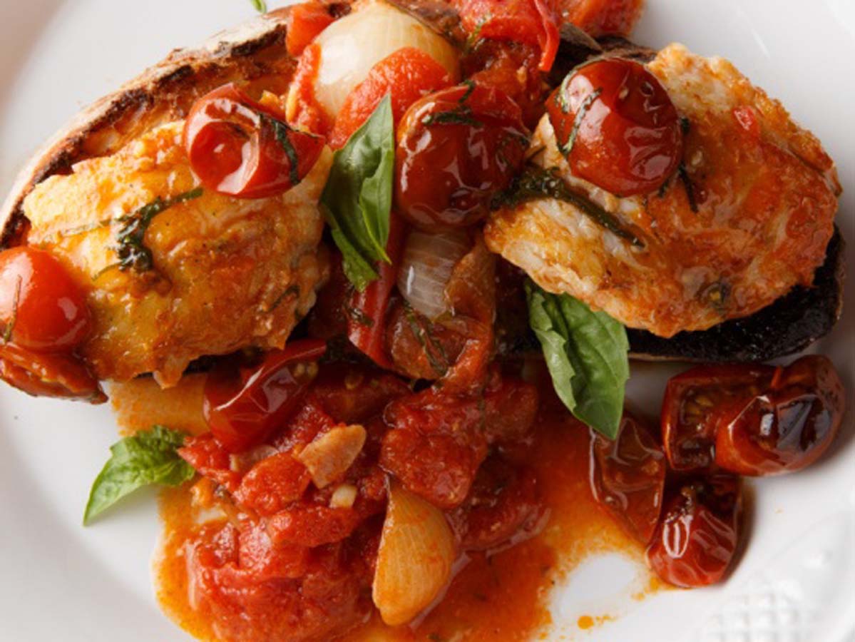 Chunks of fresh meaty monkfish fish poached in a robust, spicy tomato herb sauce.