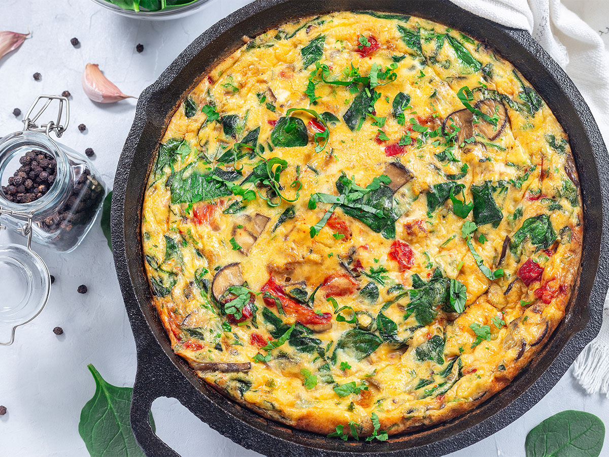 A perfectly folded breakfast omelet filled with earthy sautéed mushrooms and cheddar cheese.