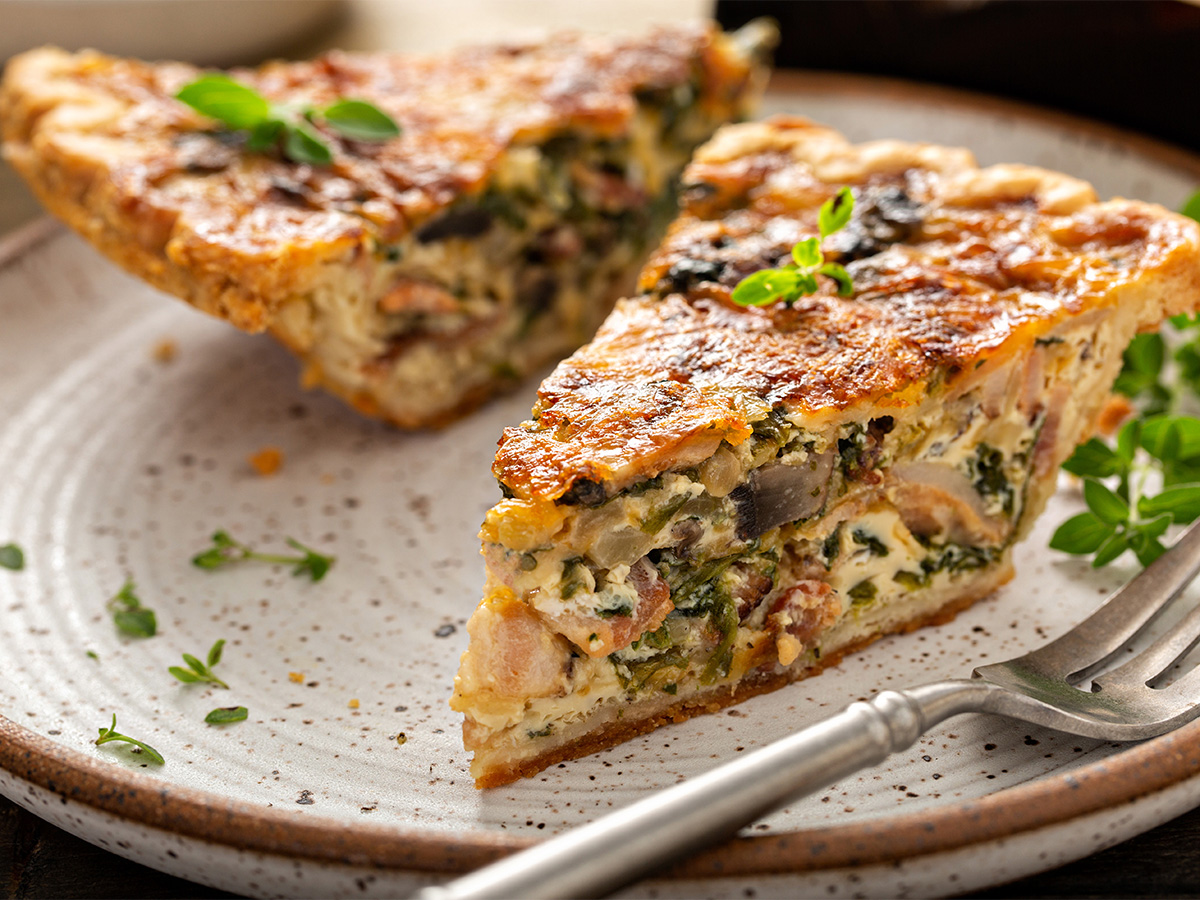A delicious quiche featuring earthy sautéed mushrooms, sweet onion marmalade, and melted cheese.