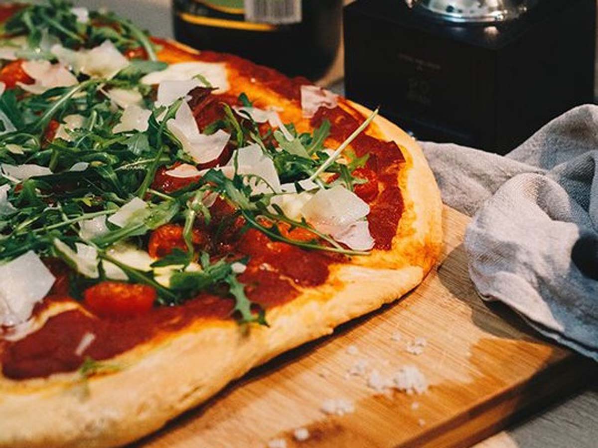 A freshly kneaded, round and soft pizza base dough ready for toppings.