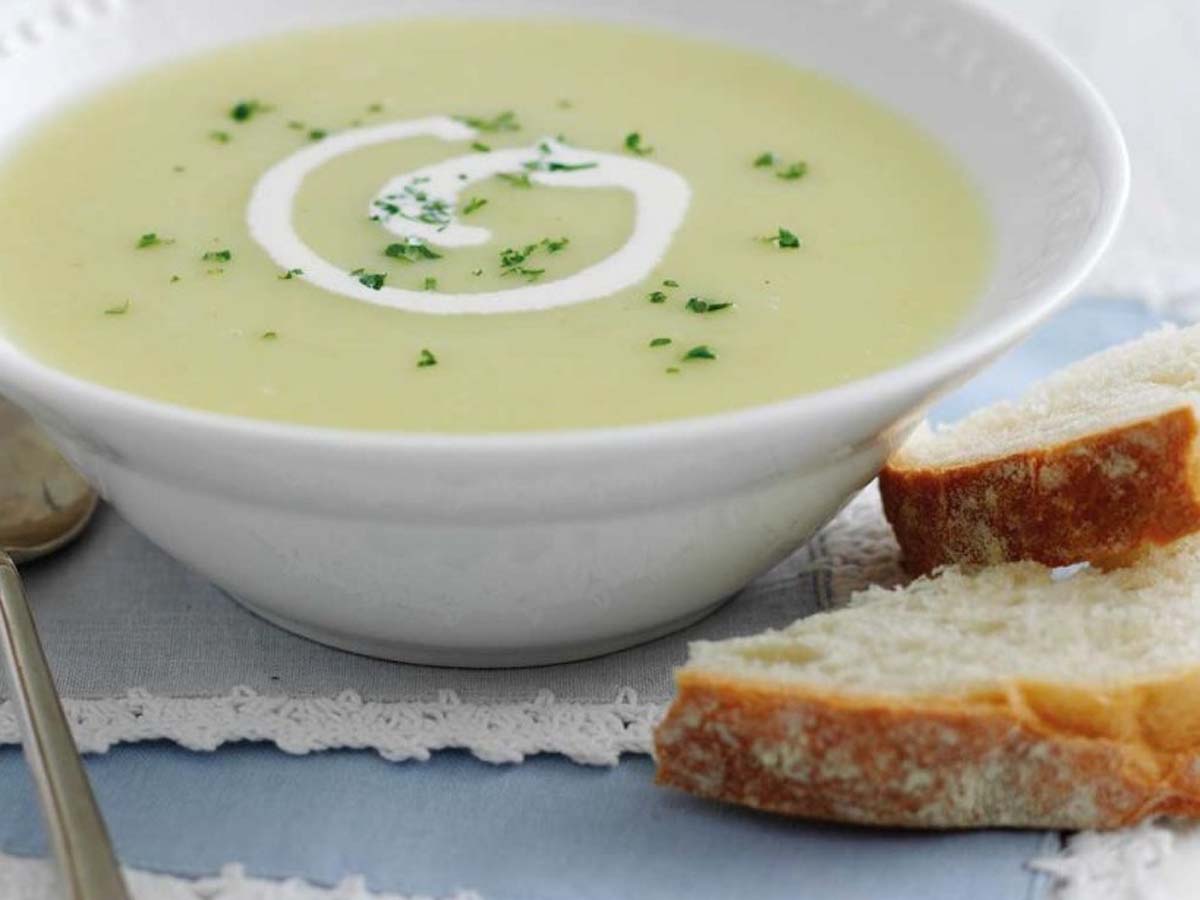 A thick, comforting creamy potato and leek soup garnished with fresh chives.