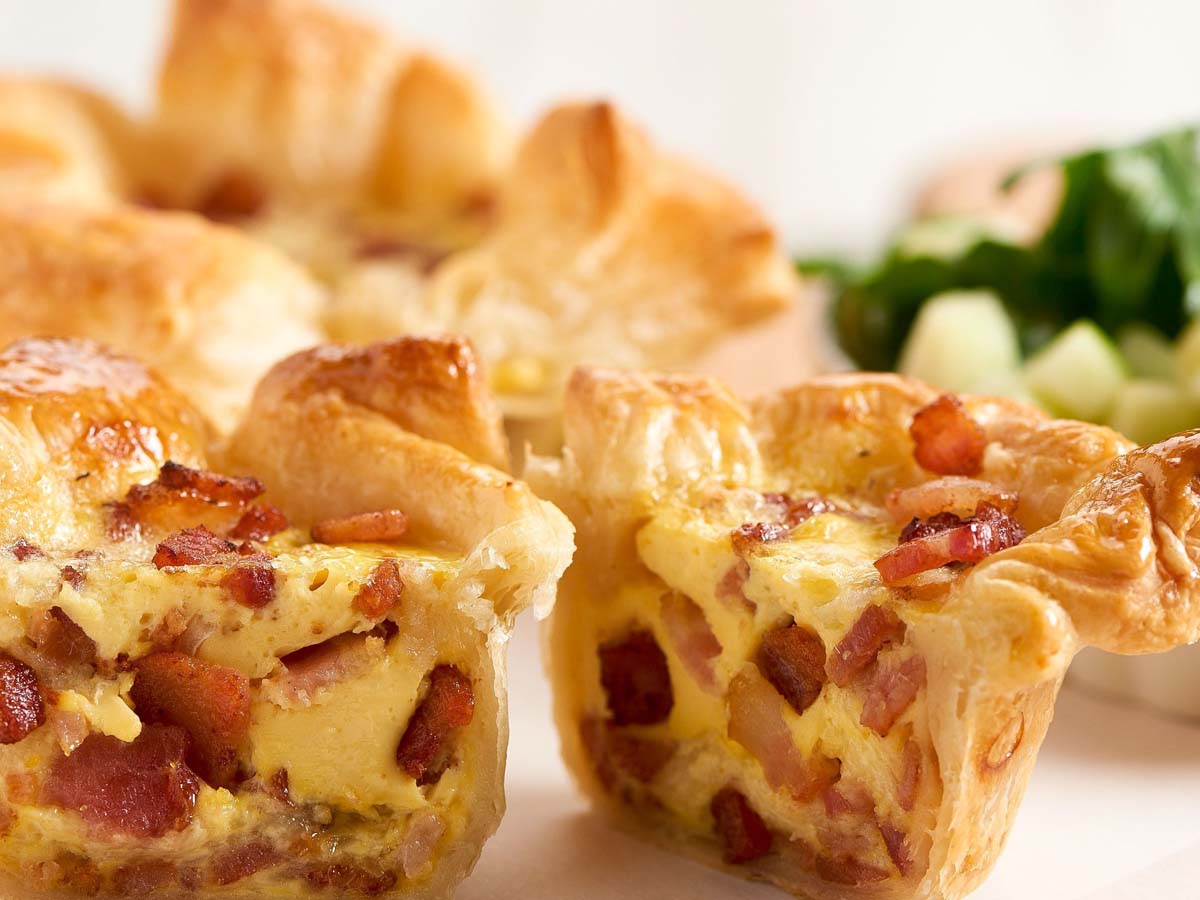 A classic French savoury Quiche Lorraine with a crisp pastry base and bacon filling.