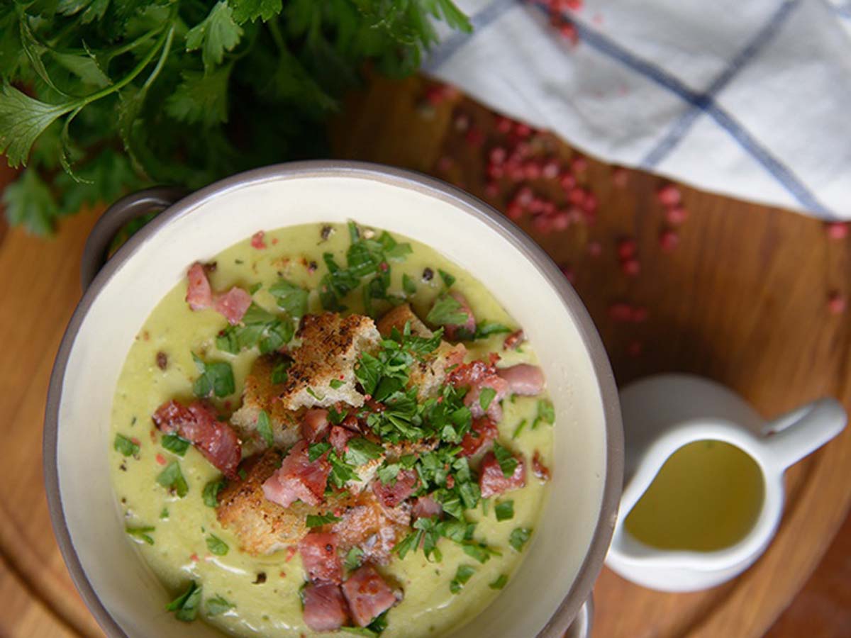 A deep bowl of quick and easy creamy chicken bacon gnocchi soup served hot with herbs.