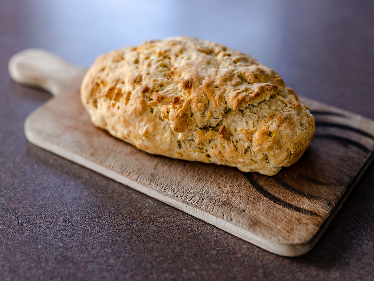 Traditional South African roosterkoek bread rolls grilled over open braai barbecue coals.