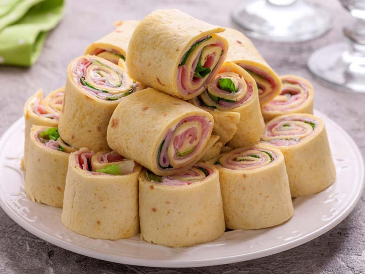 A beautiful rolled-up savoury or sweet roulade pancake sliced cleanly to show layers.