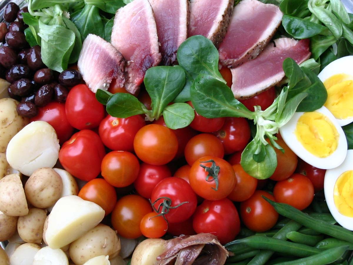 A classic Salad Nicoise with seared tuna, hard-boiled eggs, olives, and green beans.