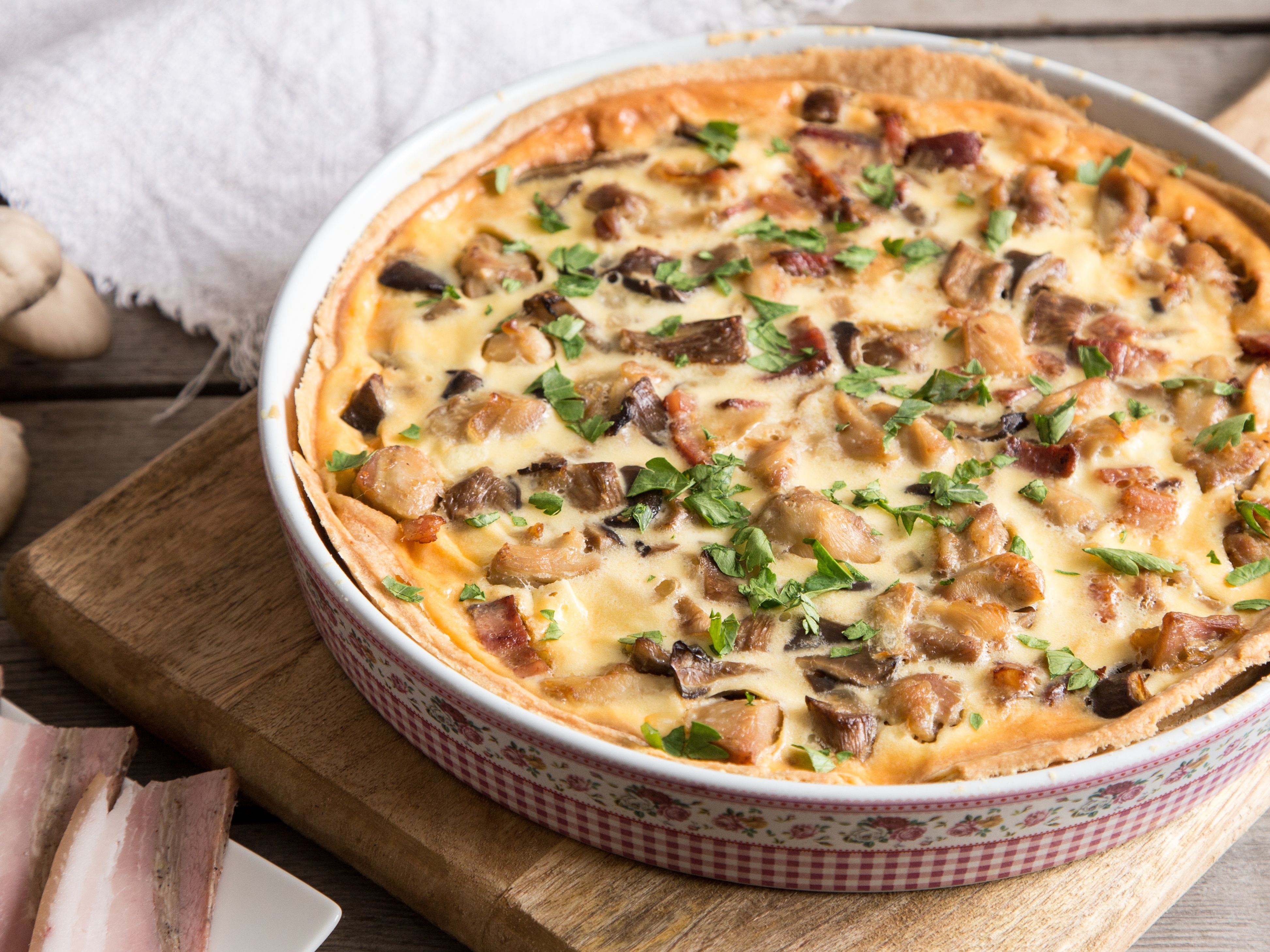 A large, rustic savoury tart or quiche loaded with roasted vegetables and cheese filling.