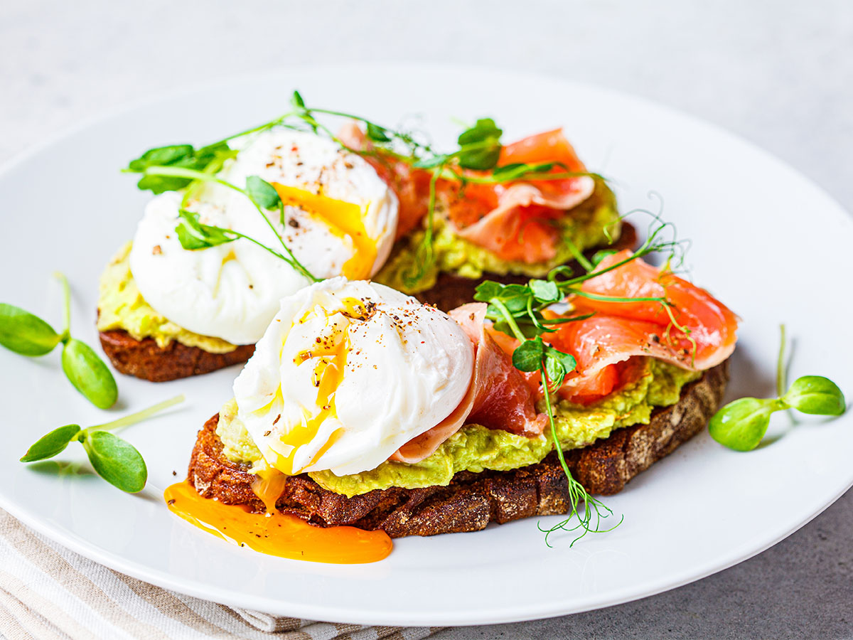 Thin slices of pink smoked salmon over fluffy scrambled eggs served on dense rye toast.