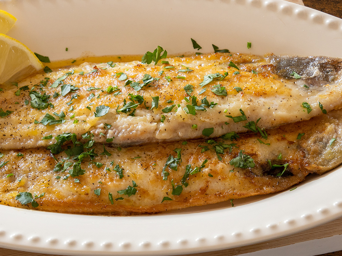 A classic French pan-fried delicate sole meuniere fish fillet in lemon butter sauce.