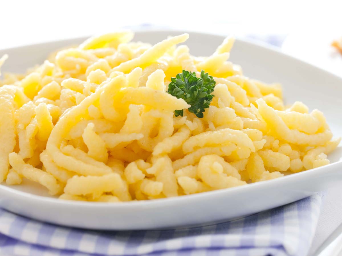 A bowl of traditional golden homemade German spaetzle egg noodles.