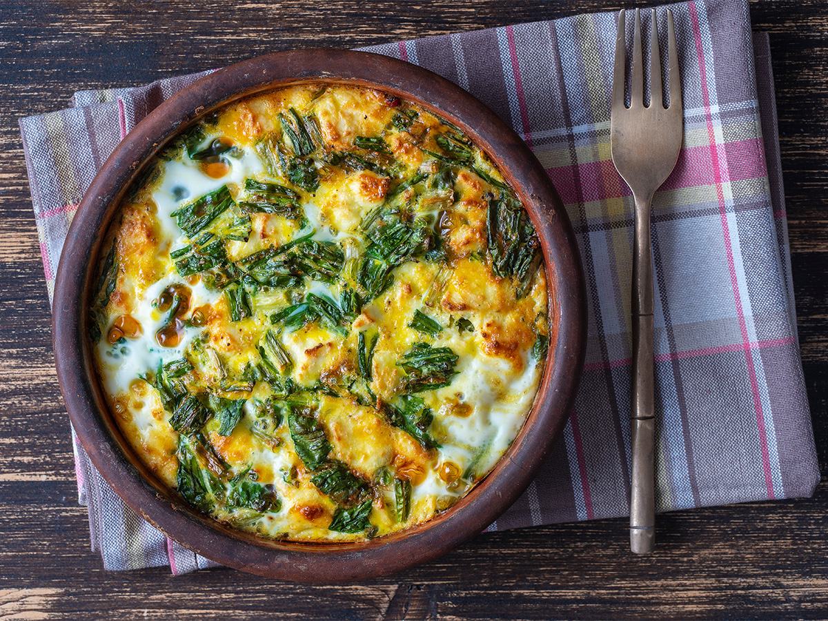 A light folded egg omelette filled with healthy green spinach and crumbled feta cheese.