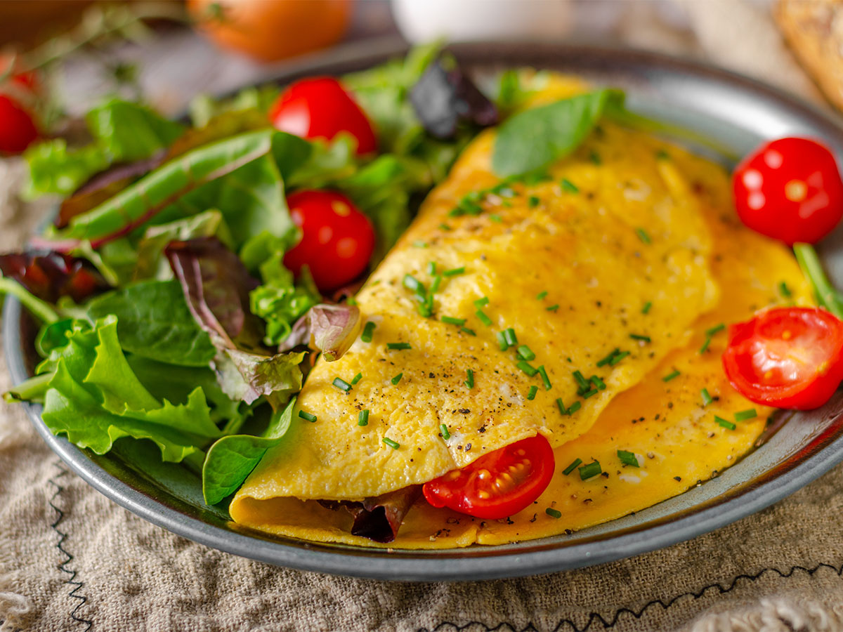 A fluffy egg omelet filled with Mediterranean sun-dried tomatoes, basil, and feta cheese.