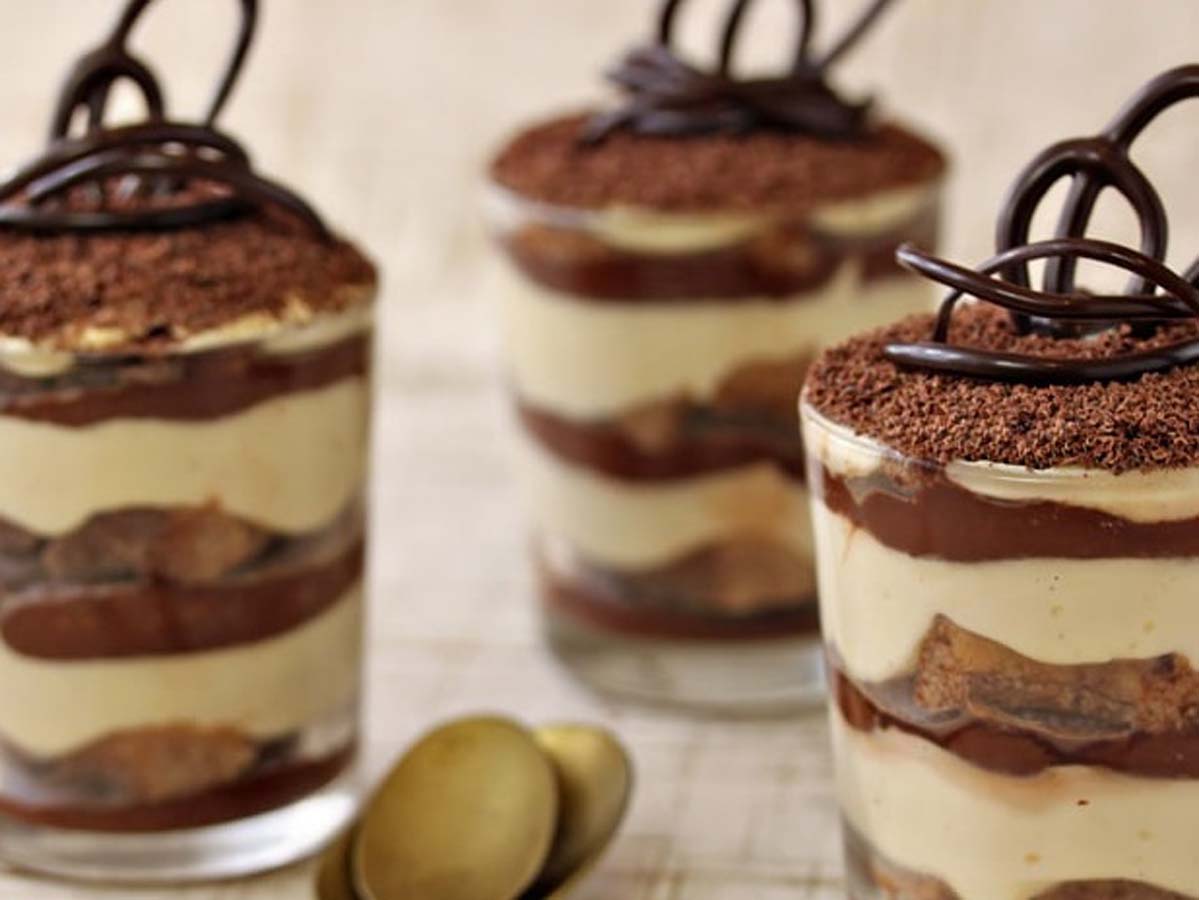 A traditional Italian classic tiramisu layered with espresso-soaked ladyfingers and cocoa powder.