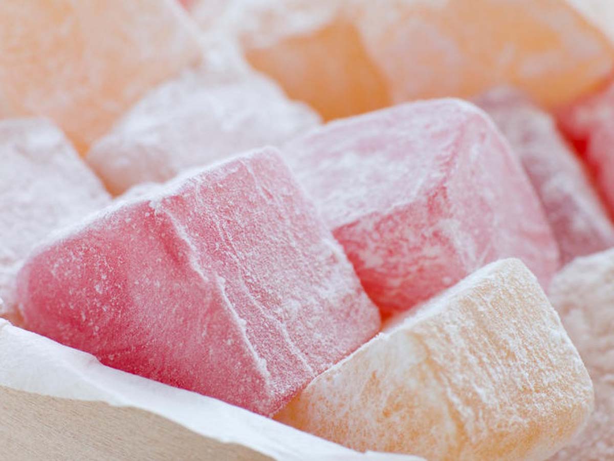 Soft, powdery pink cubes of traditional Turkish delight confectionary dusted with sugar.